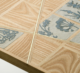 Meadow Table top design detail showing sgraffito and ash wood tiles with flashes of brass rod intersecting the design.